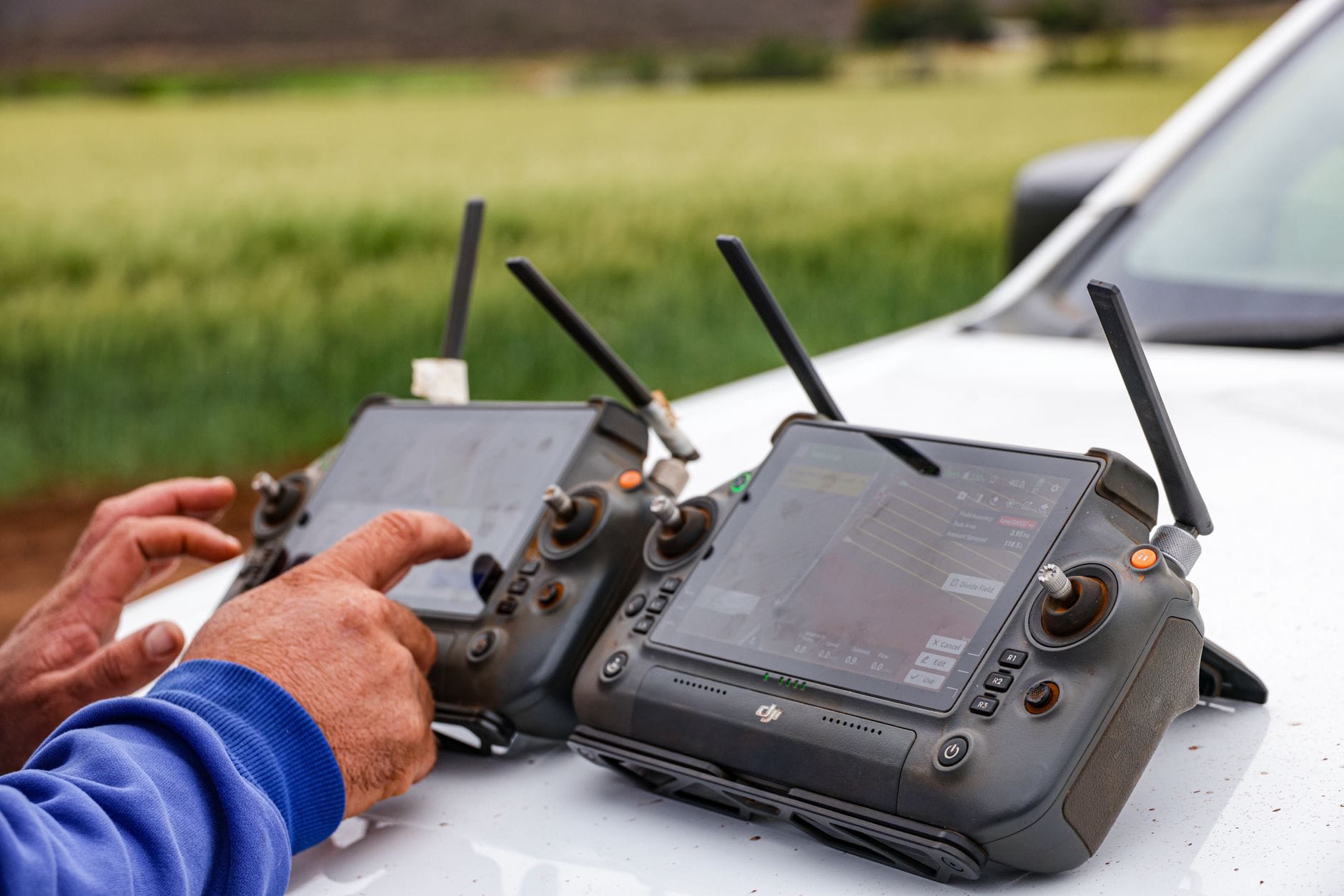Rolnicy na polu sterują dronem do precyzyjnego rolnictwa